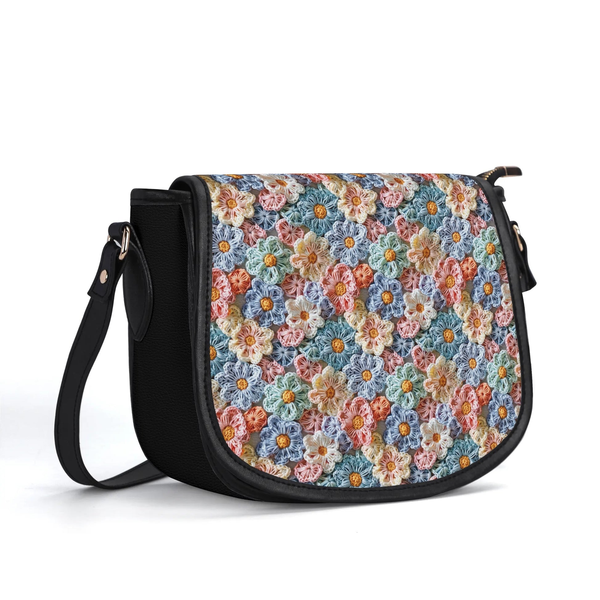 The Posy' Pock-It Saddle Handbag showcases colorful flower petals in a crochet look, with a sleek clasp and adjustable strap