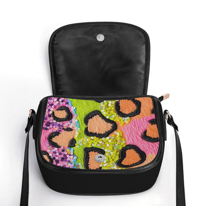 "Wild Sparkle handbag with vibrant colors and sequins, featuring secure closure and spacious interior."