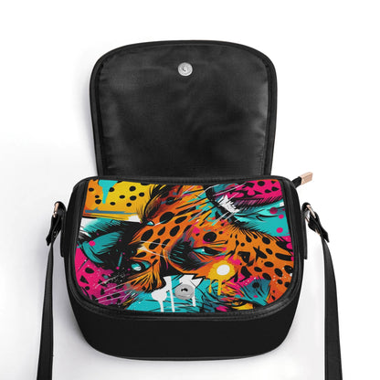 "Wild Leopard saddle handbag featuring abstract neon design with captivating eyes and secure closure."