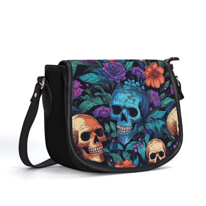 "Skull Garden saddle handbag with colorful flowers and skulls, secure closure, and ample storage space."