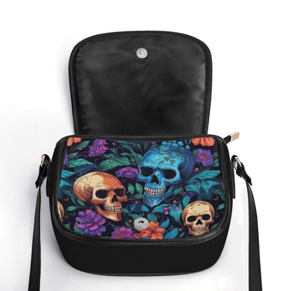 "Skull Garden saddle handbag with colorful flowers and skulls, secure closure, and ample storage space."
