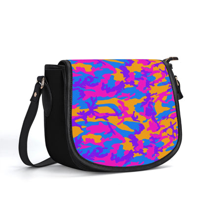 "Storm Camo saddle handbag with vibrant swirls of color, secure closure, and adjustable shoulder strap."