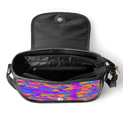 "Storm Camo saddle handbag with vibrant swirls of color, secure closure, and adjustable shoulder strap."