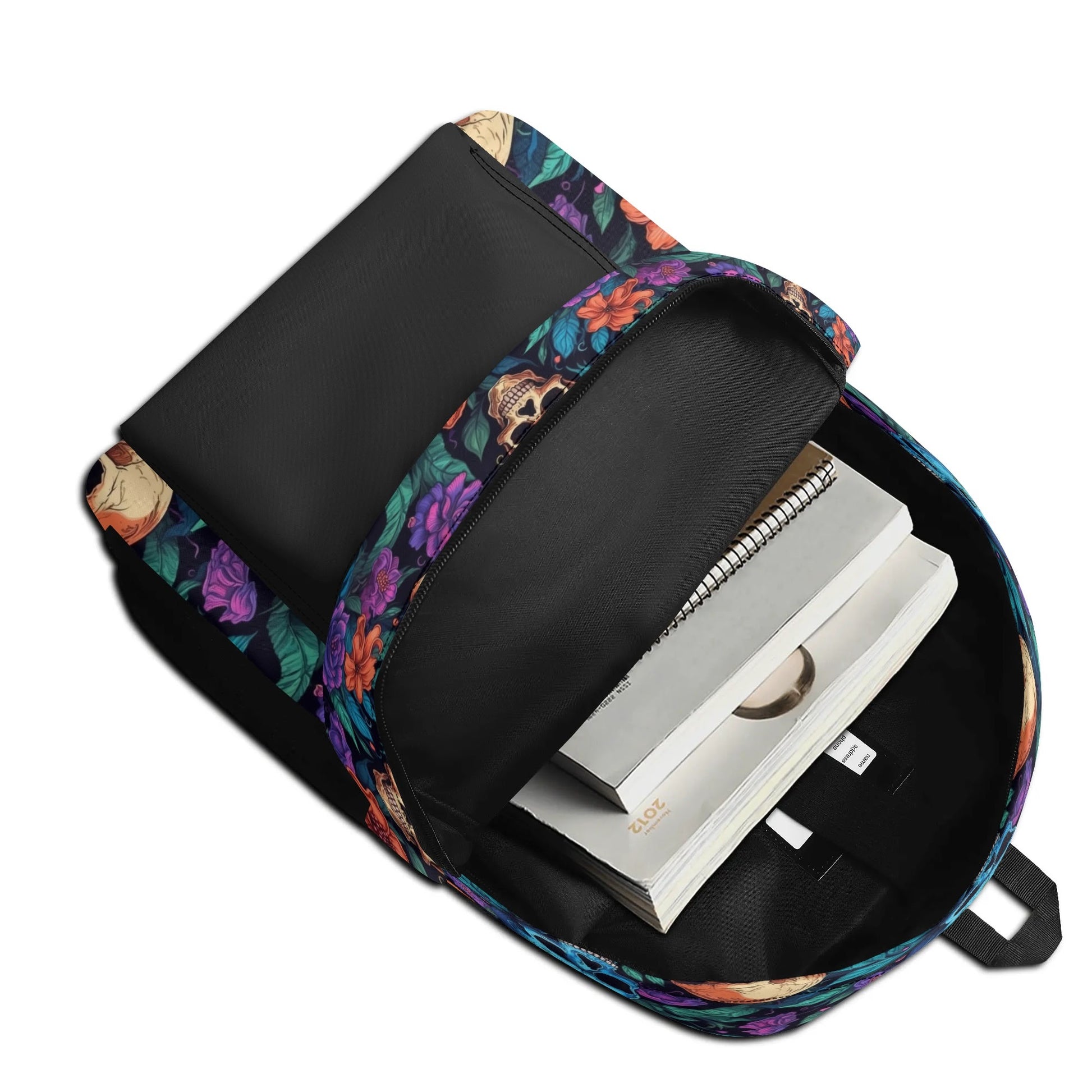 "Skull Garden Backpack features colorful flowers surrounding black and white skulls for an edgy look."