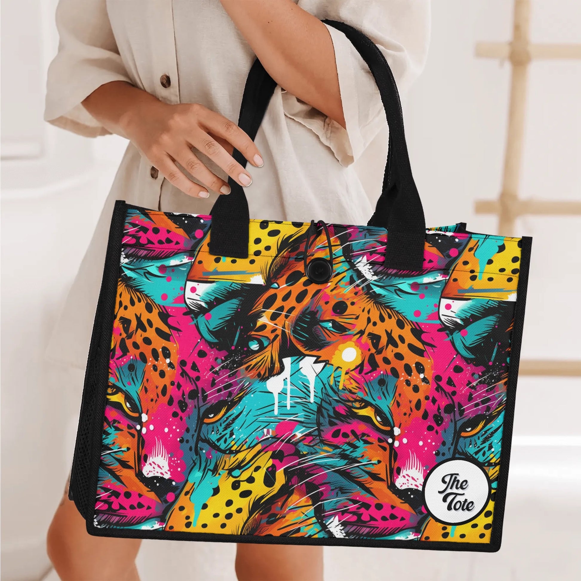 "Abstract neon leopard print tote bag by ShitHot, featuring captivating eyes peeking through vibrant spots for a wild look."