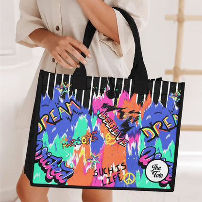 "Urban graffiti-inspired tote bag by ShitHot, blending black and white stripes with vibrant street art for bold style."