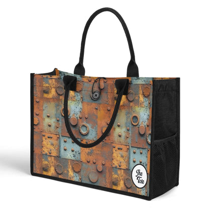 "The Tote Bag - Metal Head features oxidized panels and metal accents, available in two sizes for stylish functionality."