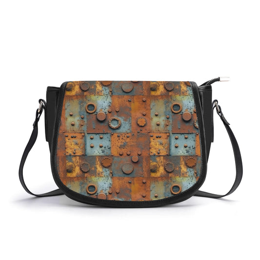 "Pock-It Saddle Handbag - Metal Head by ShitHot features oxidized panels, metal accents, and adjustable strap."