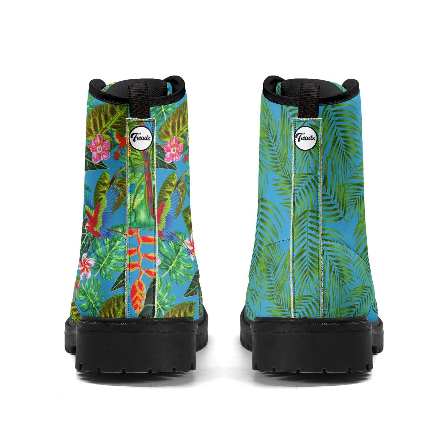 Treadz Men's Mismatch Signature Boots - Tropicana featuring vibrant tropical design with green palm leaves and colorful birds on one side, palm frond pattern on the other, set against bright blue background with black rubber sole and platform