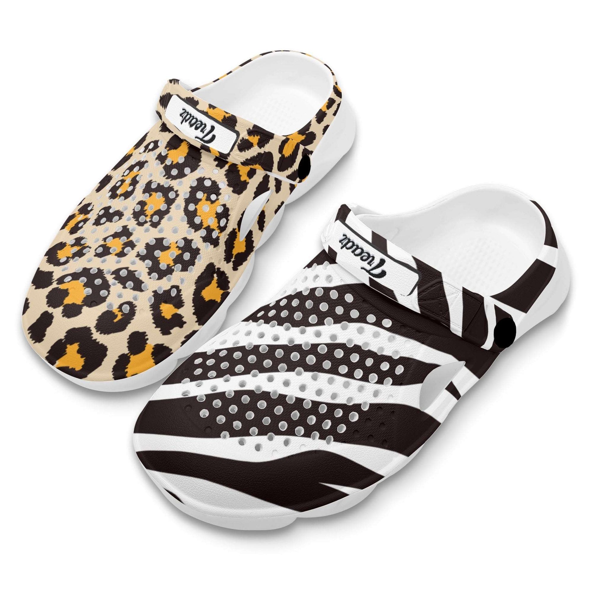 Treadz Mismatch Clogs Safari featuring contrasting zebra and leopard prints on EVA clogs, with white soles and adjustable heel straps, displaying animal patterns in black, white, tan, and orange tones.