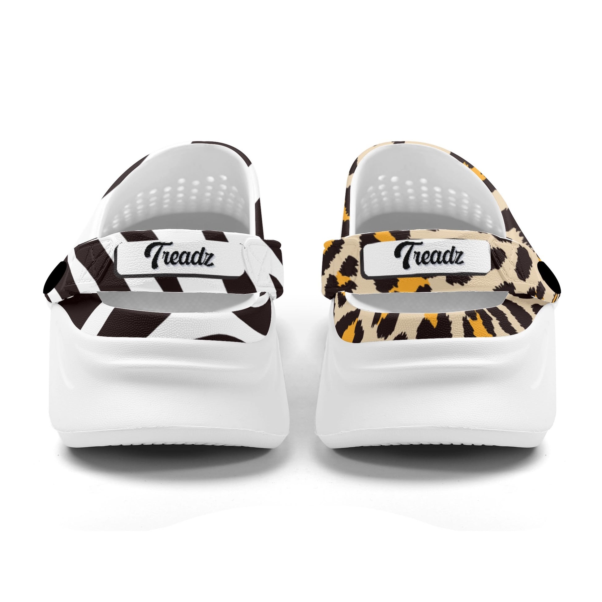 Treadz Mismatch Clogs - Safari featuring mismatched zebra and leopard print patterns on white EVA clogs with ventilation holes, adjustable heel straps, and platform soles