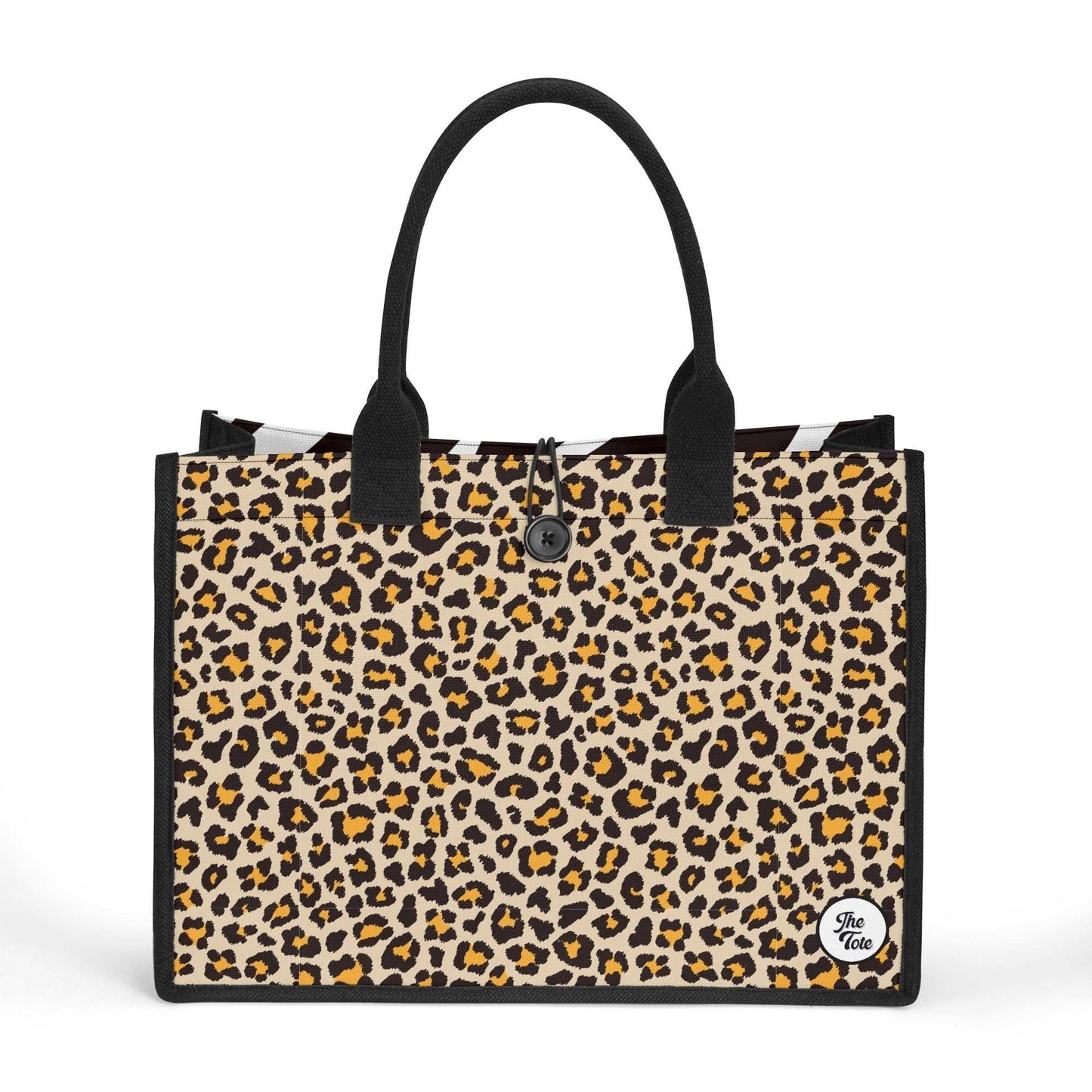 The Mismatch Tote Bag - Safari featuring a stylish leopard print canvas design with black handles and trim, showcasing a circular brand logo in the bottom corner, perfect for everyday use and shopping trips