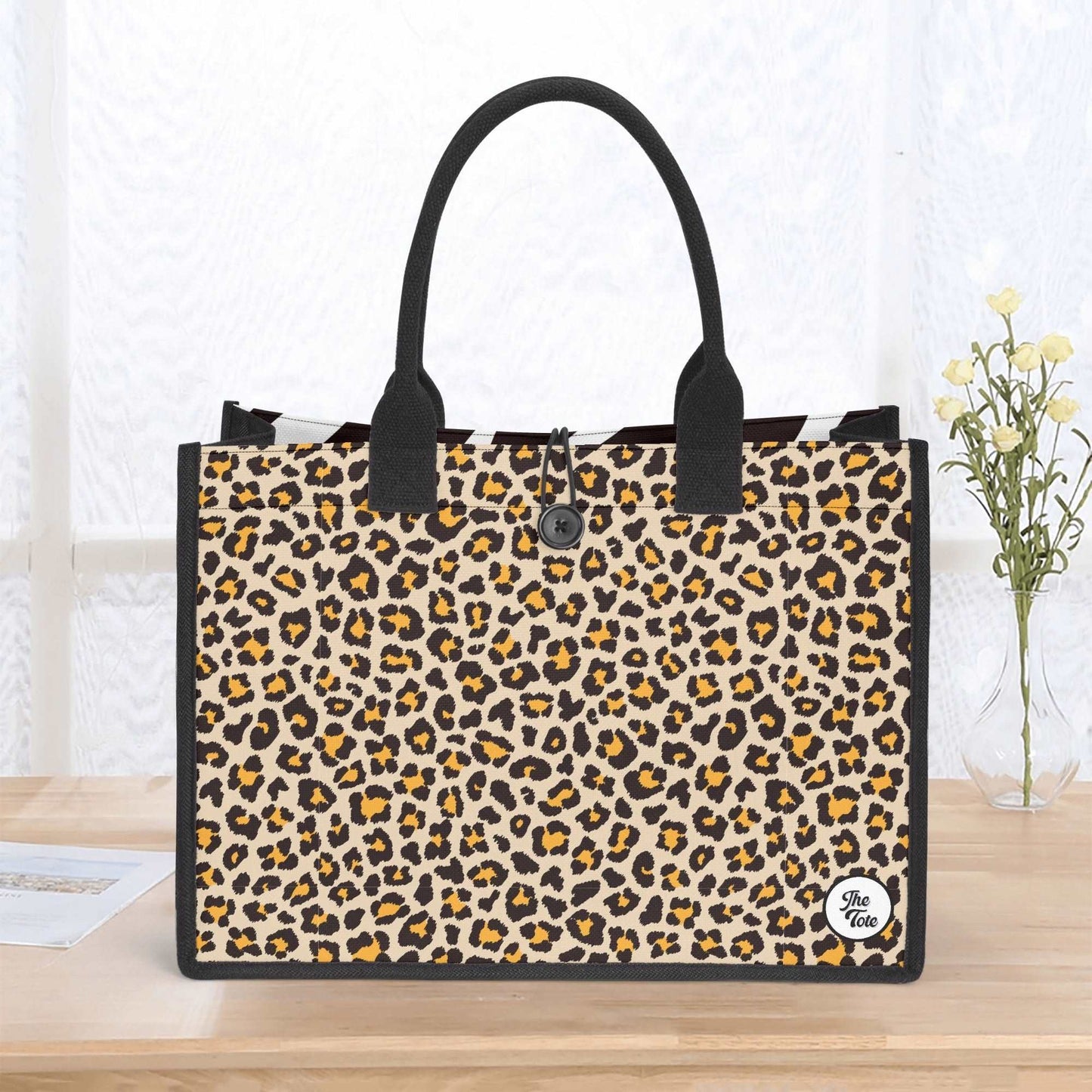 The Mismatch Tote Bag - Safari featuring stylish leopard print canvas material, black handles, structured rectangular design, and contrasting black trim, perfect for daily use and shopping