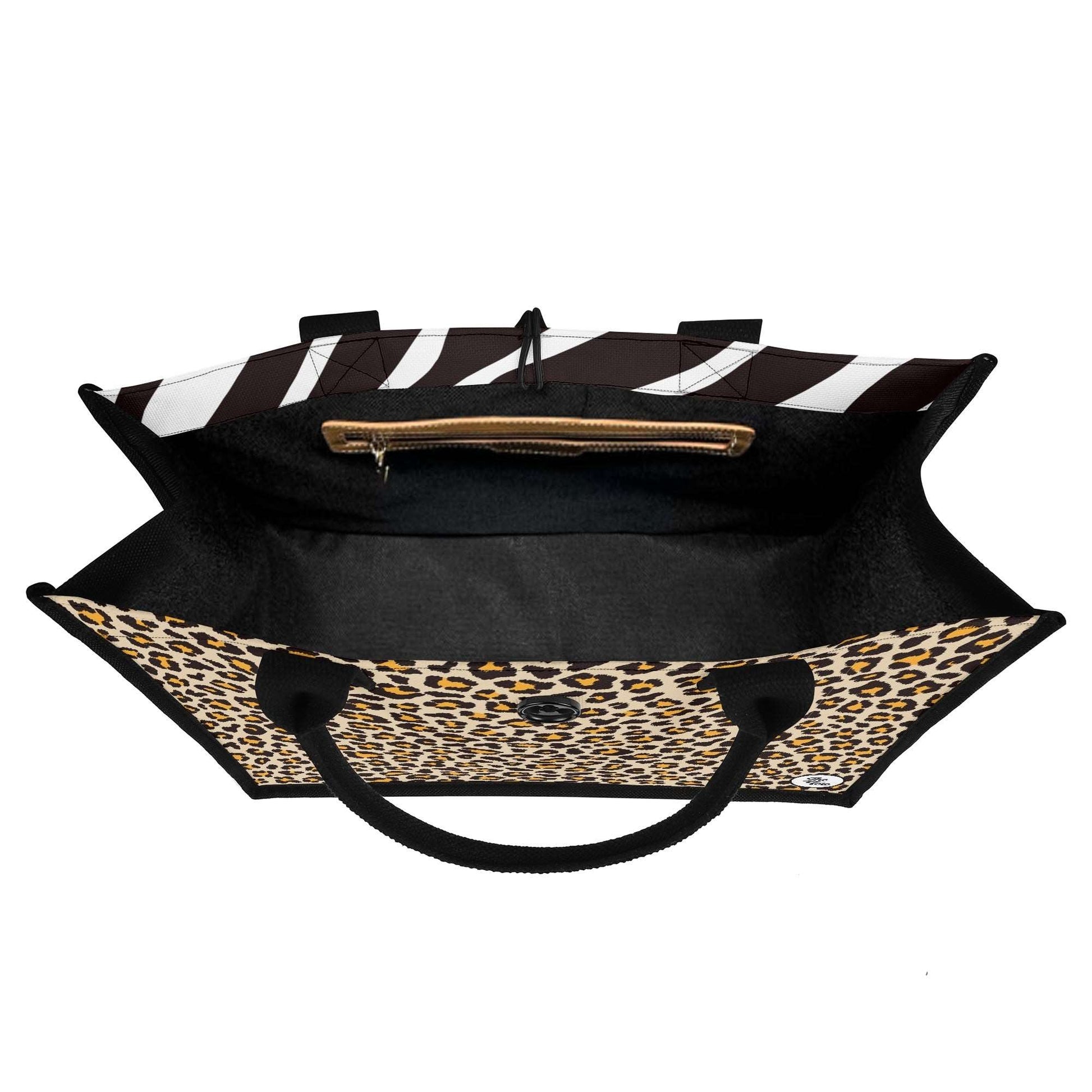 The Mismatch Tote Bag - Safari featuring dual-print design with zebra stripes on top and leopard pattern on bottom, brown zipper pocket, black handles, and spacious black interior, perfect for everyday use