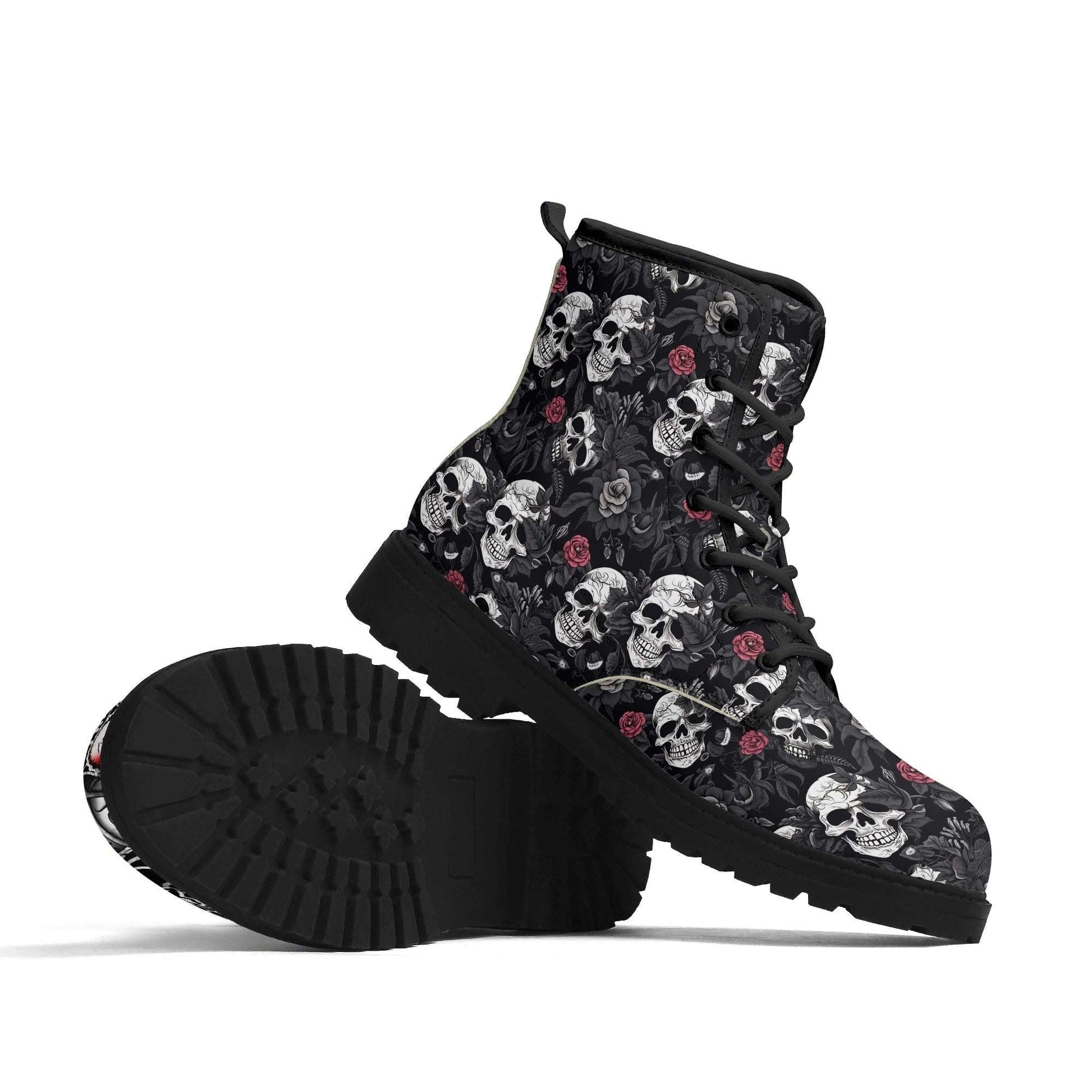 Emo Goth Mismatched Combat Boots featuring black leather-look combat boots with repeating skull and rose pattern in grey and pink on black background, chunky rubber sole, and lace-up front design. Side view shows durable construction and classic combat boot silhouette. ShitHot Best Sellers Collection.