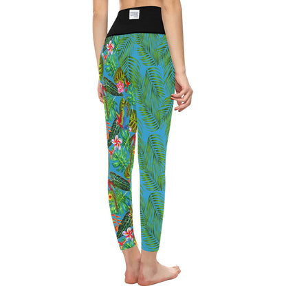 High Waisted Mismatch Core FX Mismatch Leggings - Tropicana shown from behind, featuring vibrant turquoise blue fabric with tropical green palm leaves and pink floral print pattern. Black high-rise waistband with brand label visible, form-fitting design showcasing the mismatch pattern detail.