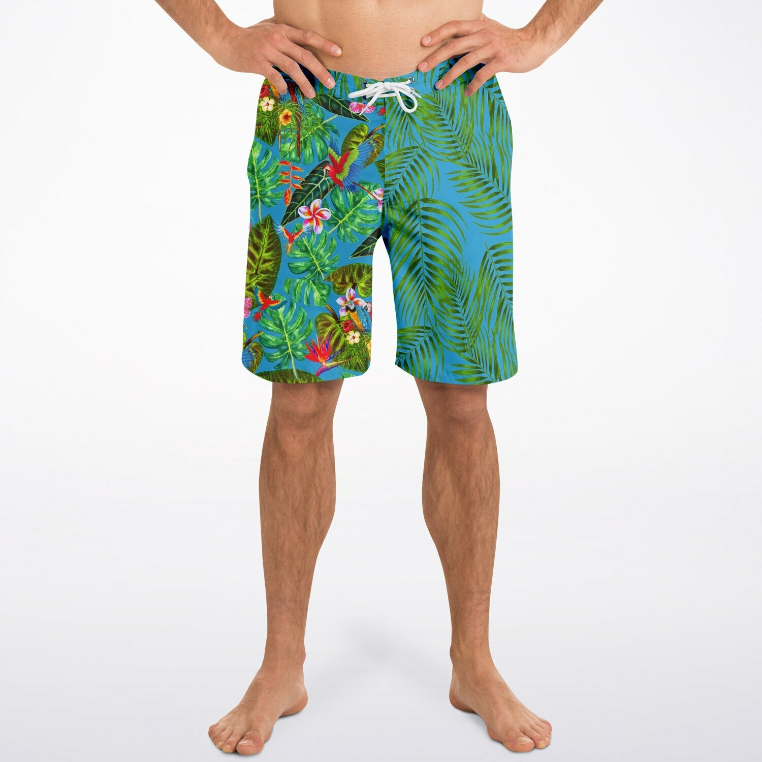 RipTide Men's Mismatch Board Shorts - Tropicana featuring asymmetrical design with vibrant green palm leaves on blue on one side and tropical foliage with birds on the other, elastic waistband with white drawstring, and mesh-lined pockets