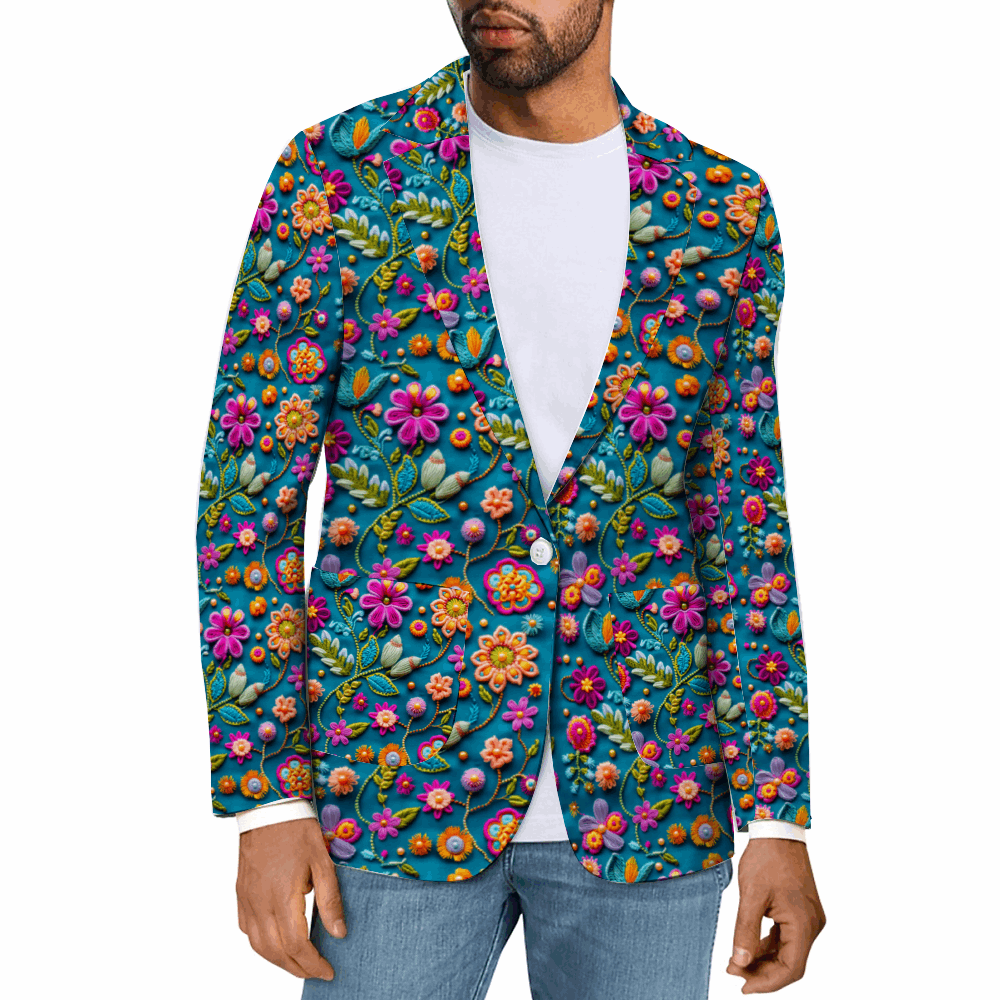 Rogue & Co. Men's Casual Blazer- Petal Pop: Vibrant floral print blazer with colorful embroidered-style flowers on teal background. Man wearing white t-shirt and jeans models the open blazer, showcasing its versatile and eye-catching design for various occasions.