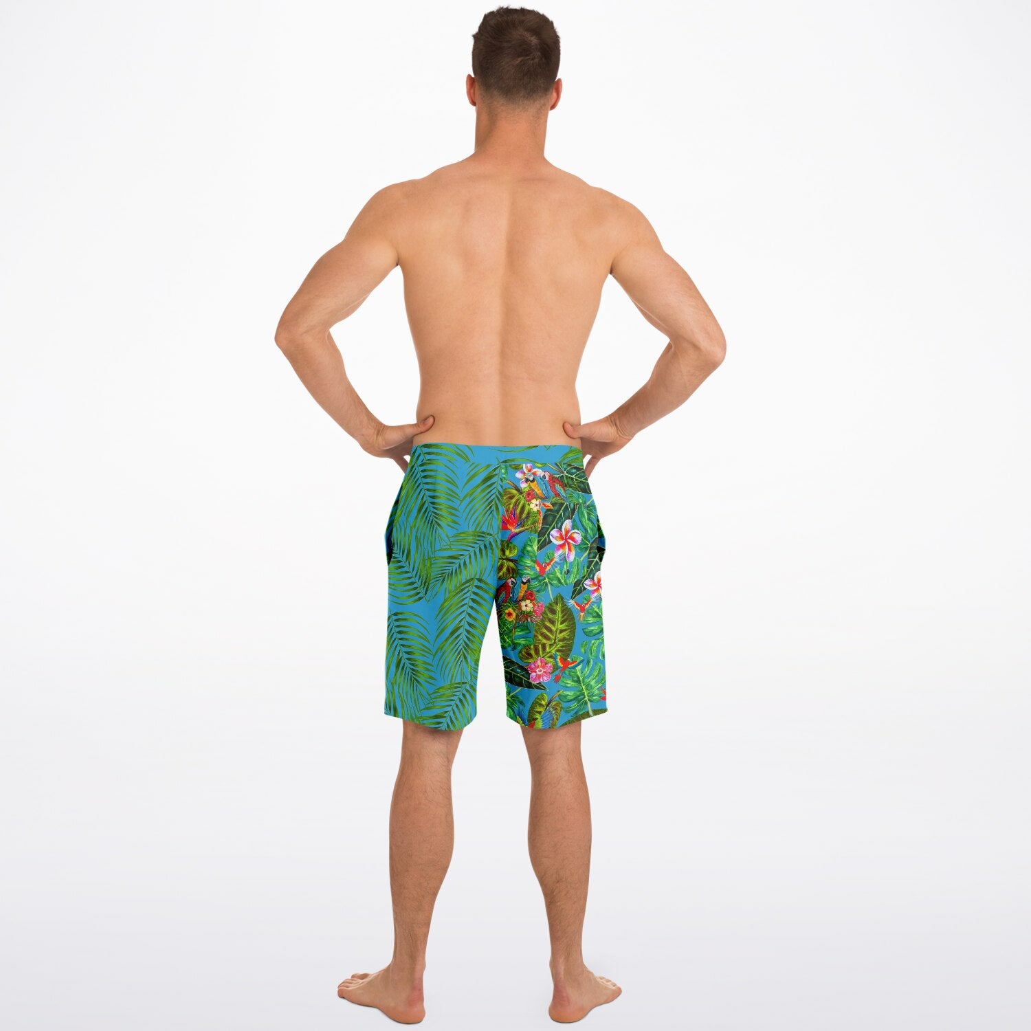 RipTide Men's Mismatch Board Shorts - Tropicana shown from back view, featuring unique split design with tropical palm leaves on blue background on one side and vibrant floral pattern with birds on turquoise background on the other side