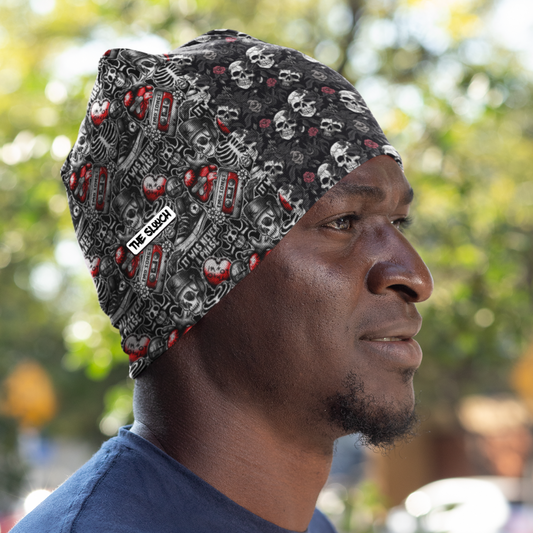 Full print Pullover cap - Mismatched Emo Vibe featuring black and grey skull pattern with red accents. Side view of beanie shows all-over print design with edgy gothic aesthetic. Stretchy polyester material perfect for casual wear and outdoor activities.