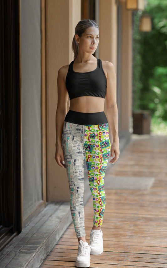 High Waisted Mismatch Core FX Leggings - Retro Media shown in lifestyle setting, featuring split design with vintage newsprint pattern on left leg and colorful retro test pattern on right leg, paired with black sports bra and white sneakers on wooden deck with natural lighting.