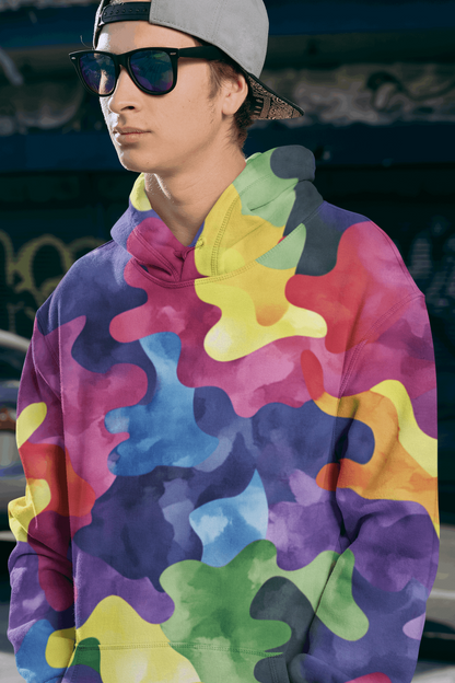 Rogue & Co Men's Hoodie - Ocean Camo showcased in vibrant multicolor design. Colorful abstract pattern on hoodie with purple, yellow, blue, and green hues. Model wearing sunglasses and backward cap, highlighting the hoodie's dynamic style and comfortable fit.